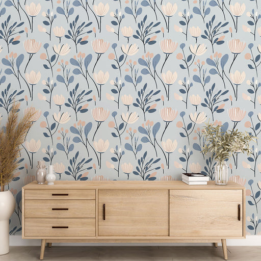 Une pièce lumineuse avec un papier peint floral aux teintes douces de bleu, rose et beige, créant une ambiance apaisante et naturelle.
