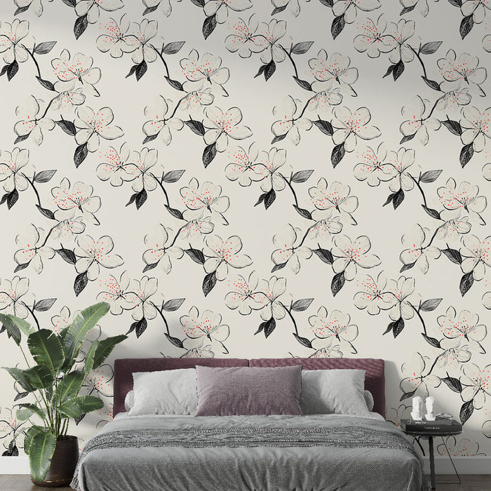Une chambre moderne avec un papier peint floral en noir et blanc, rehaussé de touches de rose, créant une atmosphère douce et élégante.