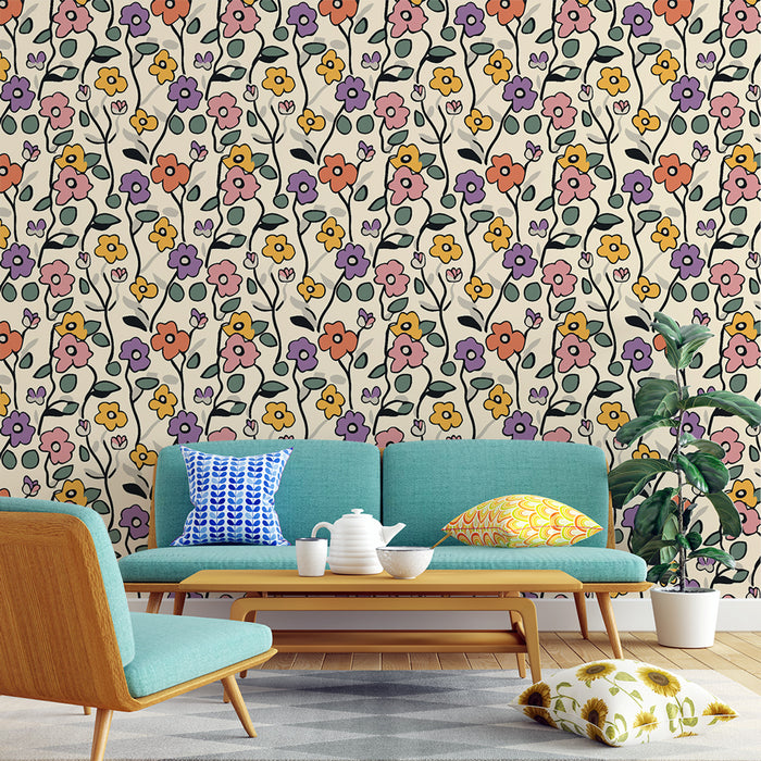 Une pièce de vie lumineuse avec un papier peint floral aux motifs colorés sur fond clair, créant une ambiance joyeuse et accueillante.