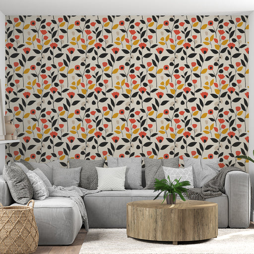 Un salon moderne avec un papier peint floral aux motifs colorés de fleurs rouges, jaunes et noires sur fond clair, créant une ambiance joyeuse et accueillante.