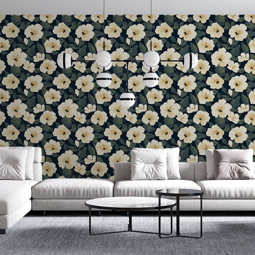 Un salon moderne avec un papier peint floral aux grandes fleurs blanches sur fond bleu nuit, créant une ambiance élégante et chaleureuse.