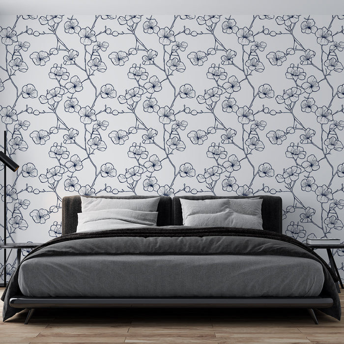 Une chambre moderne avec un papier peint floral bleu marine sur fond blanc, évoquant une ambiance douce et élégante.
