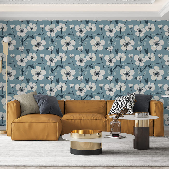 Un salon moderne avec un papier peint floral bleu et crème aux motifs de fleurs stylisées, créant une ambiance douce et accueillante.