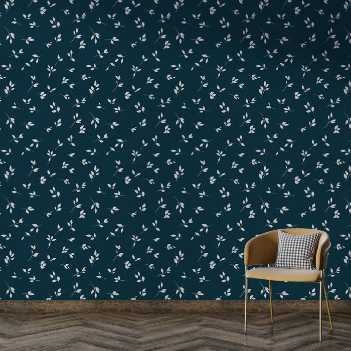 Une pièce moderne avec un papier peint bleu nuit orné de délicates feuilles blanches, créant une atmosphère élégante et apaisante.