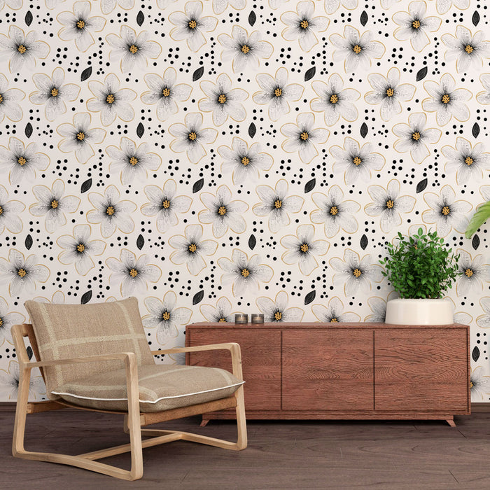 Une pièce moderne avec un papier peint floral blanc et noir, orné de grandes fleurs délicates et de touches dorées, créant une ambiance élégante et apaisante.
