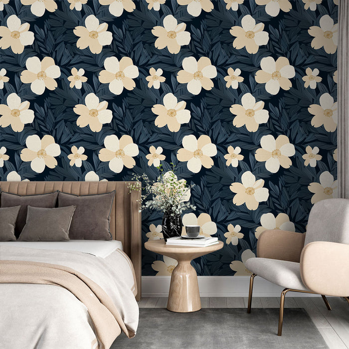 Une chambre moderne avec un papier peint floral sur fond bleu nuit, mettant en valeur de grandes fleurs crème et des feuilles délicates, créant une ambiance apaisante et élégante.
