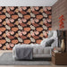 Une chambre moderne avec un papier peint floral aux teintes chaudes de rose et d'orange sur fond marron, créant une atmosphère accueillante et élégante.