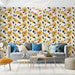 Un salon lumineux avec un papier peint floral aux grandes fleurs jaunes et noires sur fond clair, créant une ambiance chaleureuse et accueillante.