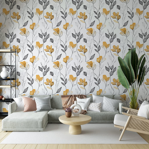 Un salon contemporain avec un papier peint floral aux motifs de fleurs jaunes et feuilles grises sur fond blanc, créant une ambiance chaleureuse et accueillante.