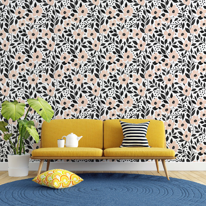 Un salon lumineux avec un papier peint floral aux motifs de fleurs roses et noires sur fond blanc, créant une ambiance joyeuse et accueillante.