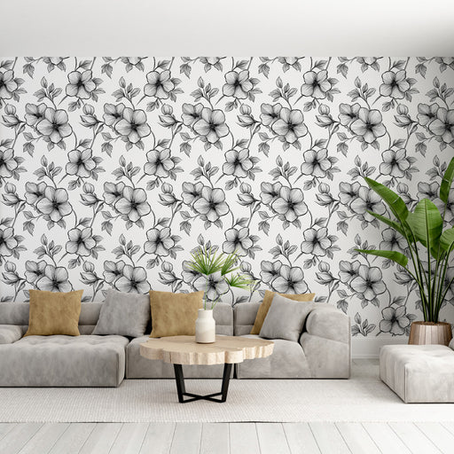Un salon moderne avec un papier peint floral noir et blanc aux motifs élégants, créant une atmosphère artistique et apaisante.