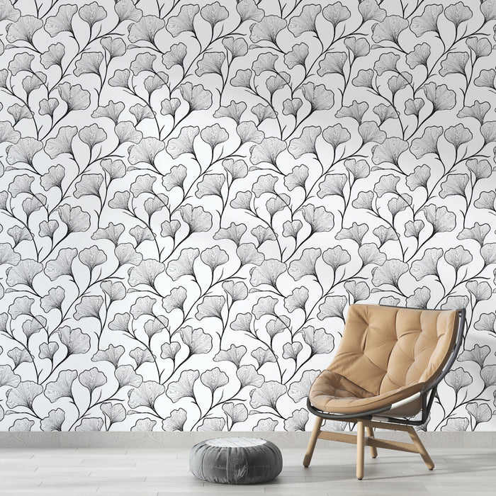 Une pièce moderne avec un papier peint floral noir et blanc représentant des feuilles délicates, créant une atmosphère élégante et apaisante.
