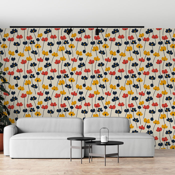 Un salon moderne avec un papier peint aux motifs floraux colorés, mêlant rouge, jaune et bleu sur fond clair, créant une ambiance joyeuse et dynamique.