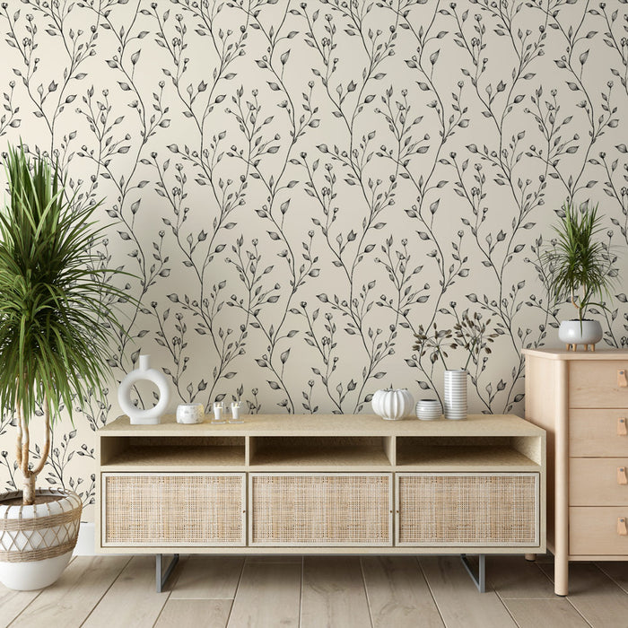 Une pièce moderne avec un papier peint floral beige orné de délicates branches noires, créant une atmosphère apaisante et élégante.