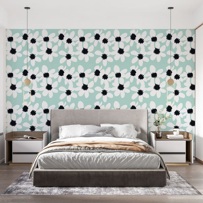 Une chambre moderne avec un papier peint floral aux grandes fleurs blanches et noires sur fond bleu clair, créant une ambiance fraîche et joyeuse.