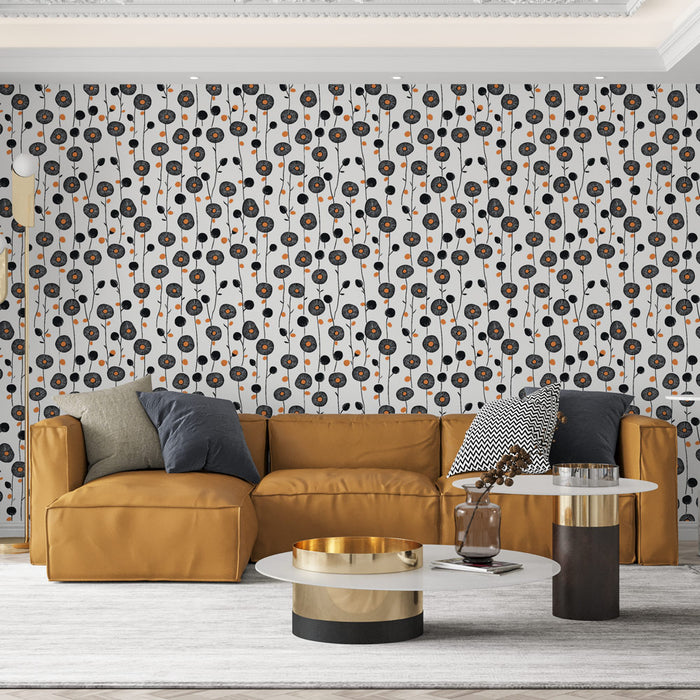 Un salon moderne avec un papier peint floral aux motifs noirs et orange sur fond blanc, créant une atmosphère dynamique et accueillante.