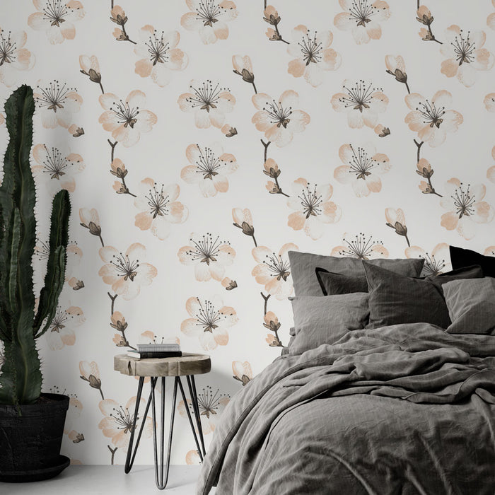Une chambre moderne avec un papier peint floral aux motifs de fleurs blanches et pêche sur fond clair, créant une ambiance douce et apaisante.
