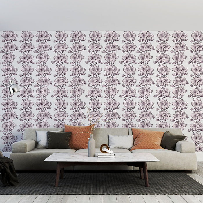Un salon moderne avec un papier peint floral aux motifs de fleurs mauves sur fond clair, créant une ambiance douce et élégante.