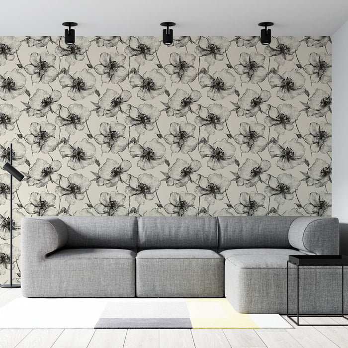 Un salon moderne avec un papier peint floral noir et blanc représentant des fleurs délicates sur un fond beige, créant une atmosphère élégante et apaisante.