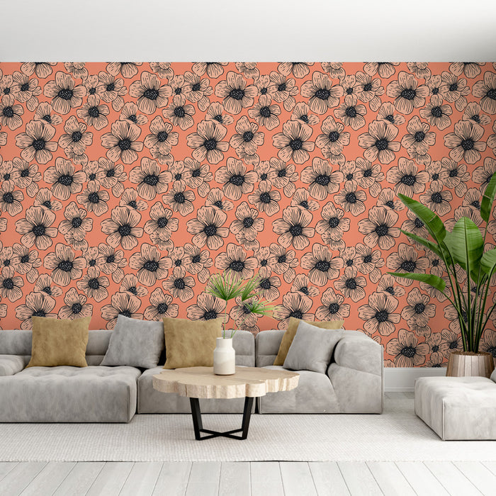 Un salon moderne avec un papier peint floral aux grandes fleurs noires sur fond corail, créant une atmosphère chaleureuse et accueillante.