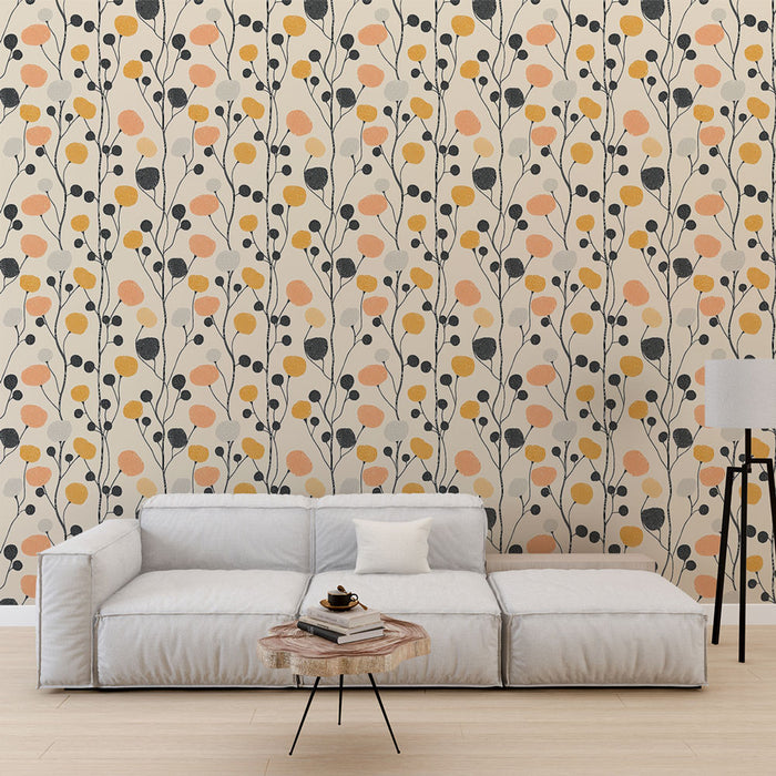 Un salon moderne avec un papier peint floral aux motifs de feuilles stylisées en noir, orange et jaune sur fond clair, créant une ambiance chaleureuse et accueillante.