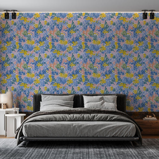 Une chambre moderne avec un papier peint floral aux teintes pastel, mêlant des motifs de feuillages verts, jaunes et roses, créant une atmosphère fraîche et joyeuse.