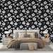 Une chambre élégante avec un papier peint floral noir et blanc aux motifs délicats, créant une atmosphère à la fois moderne et apaisante.