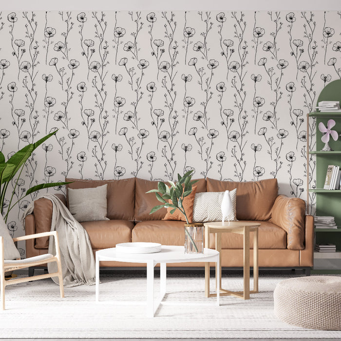 Un salon moderne avec un papier peint floral noir et blanc représentant des fleurs délicates, créant une ambiance élégante et apaisante.