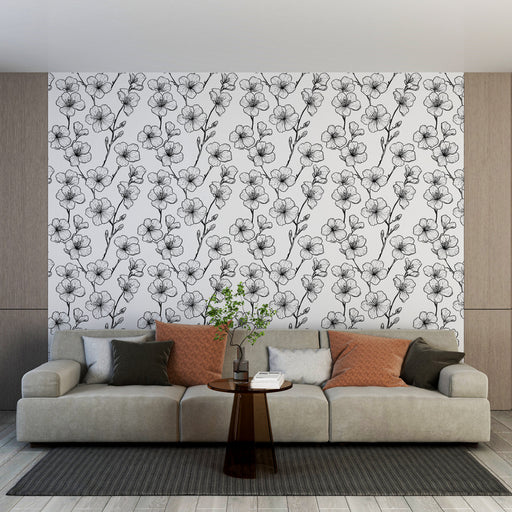 Un salon moderne avec un papier peint floral en noir et blanc, présentant des motifs délicats de fleurs, créant une ambiance élégante et apaisante.
