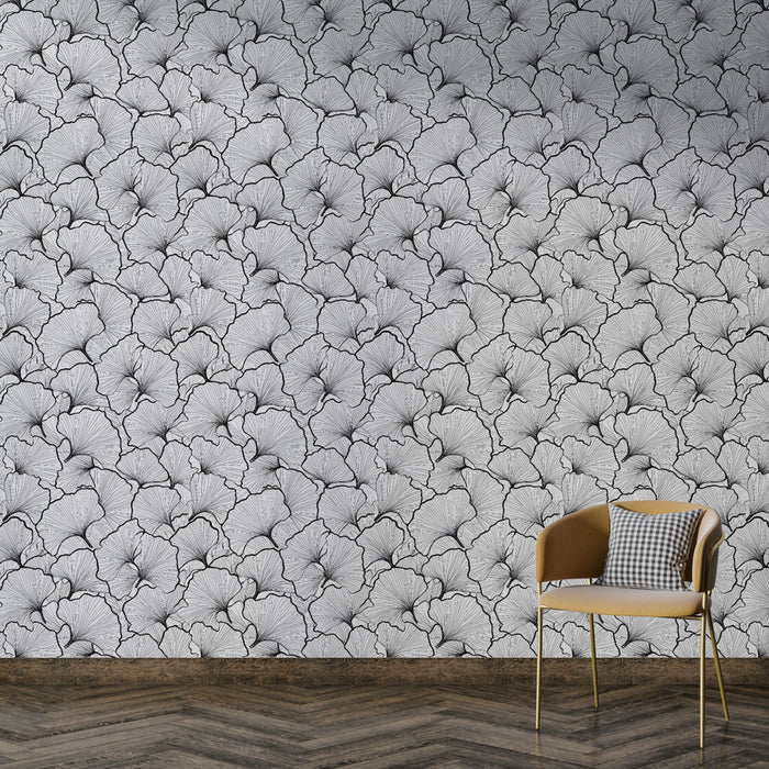 Une pièce moderne avec un papier peint monochrome représentant des motifs de feuilles délicates, créant une ambiance élégante et artistique.