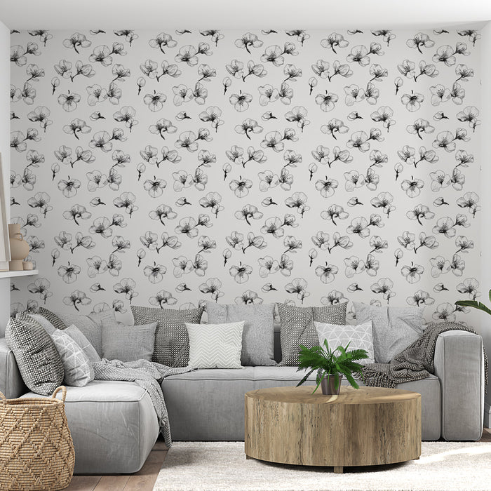 Un salon moderne avec un papier peint floral en noir et blanc, présentant des motifs délicats de fleurs sur fond clair, créant une ambiance élégante et apaisante.
