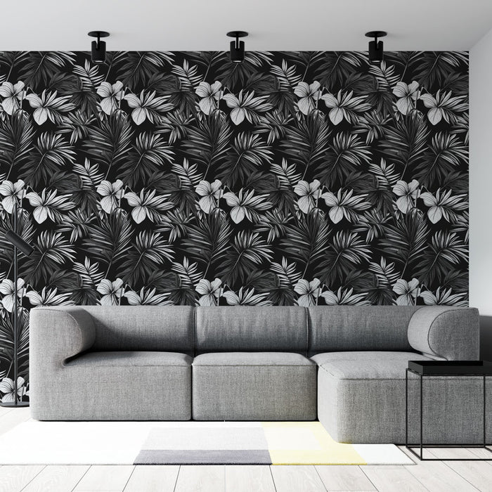 Un salon moderne avec un papier peint tropical noir et blanc aux motifs de feuilles et fleurs exotiques, créant une ambiance élégante et dynamique.