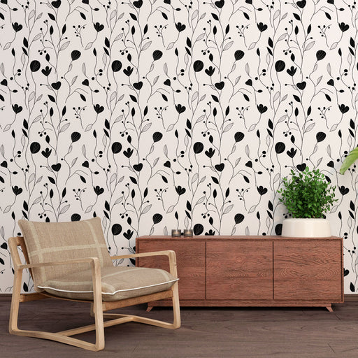 Une pièce moderne avec un papier peint floral noir et blanc aux motifs délicats de plantes, créant une atmosphère élégante et apaisante.