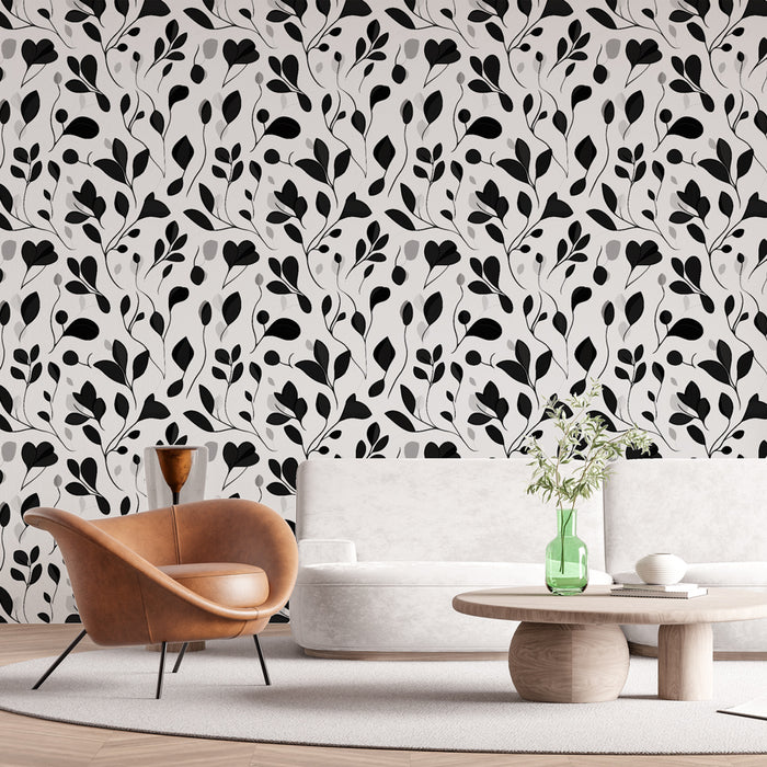 Un salon moderne avec un papier peint floral noir et blanc aux motifs délicats de feuilles, créant une ambiance élégante et contemporaine.