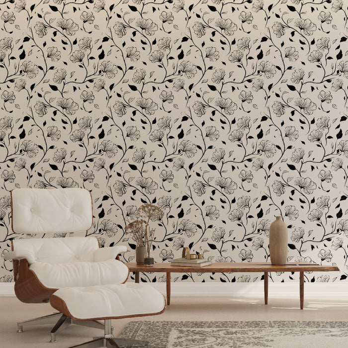 Un salon élégant avec un papier peint floral noir et blanc aux motifs délicats de fleurs et de feuilles, créant une atmosphère artistique et apaisante.
