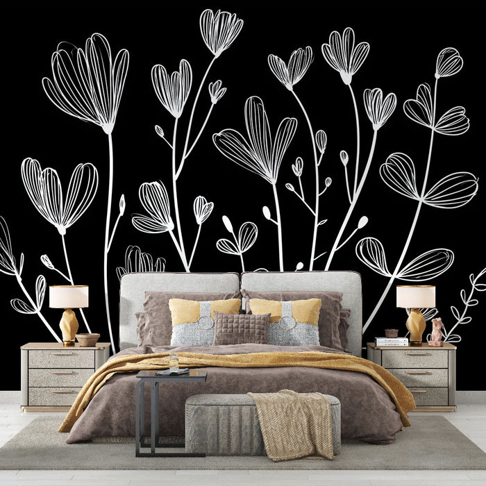 Une chambre élégante avec un papier peint floral blanc sur fond noir, créant une atmosphère moderne et artistique.