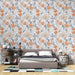 Une chambre moderne avec un papier peint floral aux teintes douces d'orange et de gris, créant une ambiance chaleureuse et accueillante.