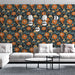 Un salon moderne avec un papier peint floral aux grandes fleurs orange et bleues sur fond noir, créant une ambiance chaleureuse et dynamique.