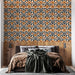 Une chambre moderne avec un papier peint floral aux motifs orange et noir sur fond clair, créant une atmosphère chaleureuse et accueillante.