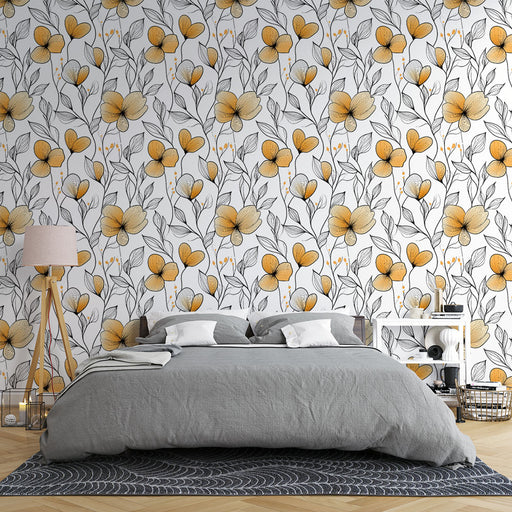 Une chambre moderne avec un papier peint floral aux motifs de grandes fleurs jaunes et feuilles noires sur fond blanc, créant une ambiance lumineuse et joyeuse.