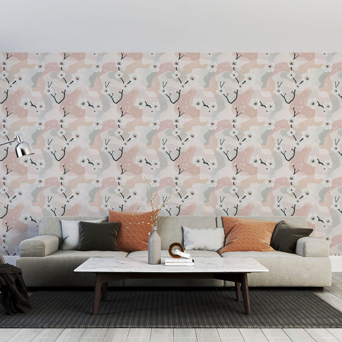Un salon moderne avec un papier peint aux motifs abstraits et floraux dans des teintes douces de rose, gris et blanc, créant une atmosphère chaleureuse et accueillante.