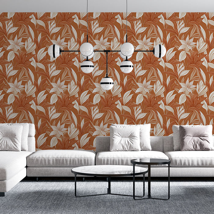 Un salon contemporain avec un papier peint floral aux teintes chaudes de terracotta et des motifs de feuilles et fleurs blanches, créant une atmosphère accueillante et dynamique.