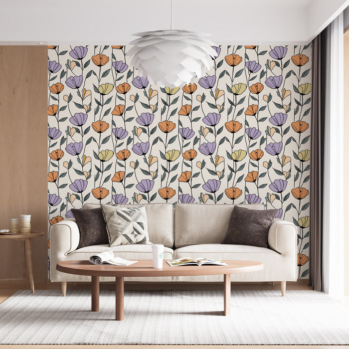 Une pièce lumineuse avec un papier peint floral aux motifs colorés d'orange, violet et jaune sur fond clair, créant une ambiance joyeuse et accueillante.