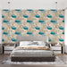Une chambre moderne avec un papier peint aux motifs organiques de galets dans des teintes beige, turquoise et bleu, créant une ambiance apaisante et naturelle.