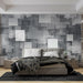 Une chambre moderne avec un papier peint abstrait en nuances de gris, présentant des formes géométriques superposées qui créent une ambiance contemporaine et dynamique.