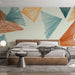 Une chambre moderne avec un papier peint graphique aux formes géométriques en bleu, orange et beige, créant une ambiance dynamique et chaleureuse.