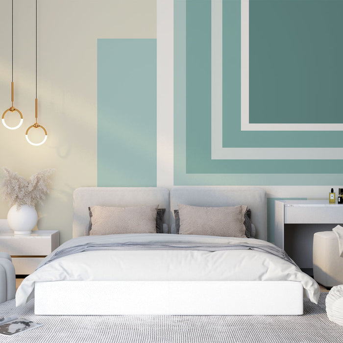 Une chambre moderne avec un papier peint aux formes géométriques en dégradés de bleu et blanc, créant une atmosphère apaisante et contemporaine.