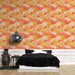 Une chambre moderne avec un papier peint aux motifs de feuilles de ginkgo en dégradé de rose, orange et jaune, créant une atmosphère chaleureuse et accueillante.