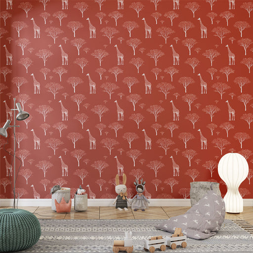 Une chambre d'enfant avec un papier peint terracotta illustrant des girafes et des arbres stylisés, créant une ambiance ludique et chaleureuse.