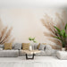 Un salon moderne avec un papier peint aux motifs de plantes sèches dans des teintes beige et crème, créant une atmosphère douce et naturelle.